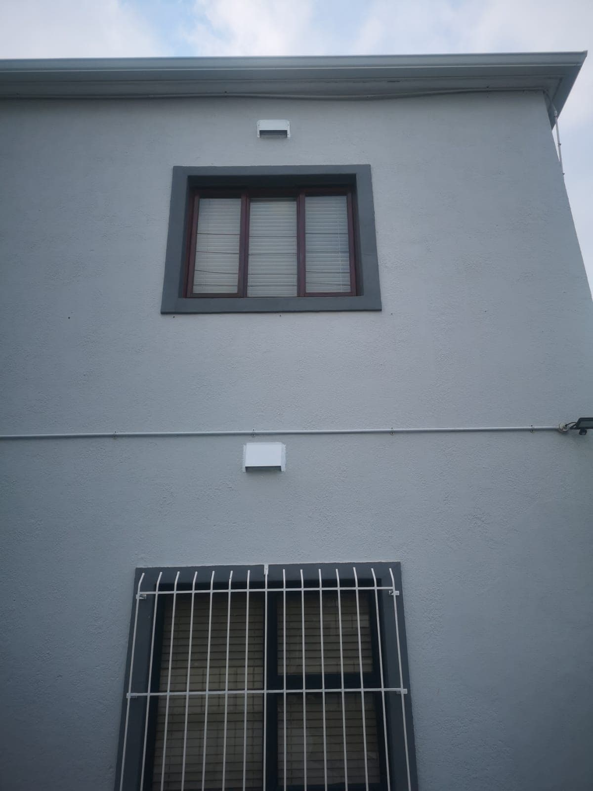 Correctly installed vent cover, unobstructed and flush against the wall
